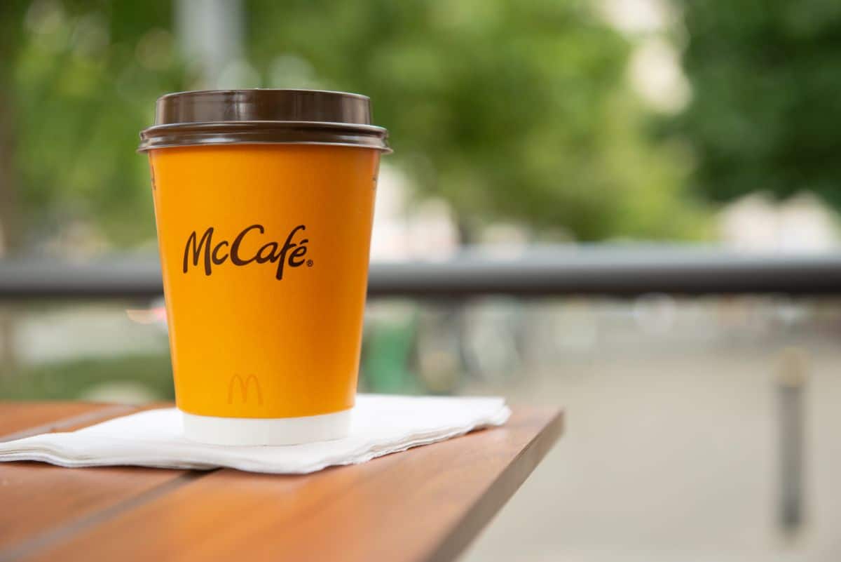 A cup of McCafe on a table.