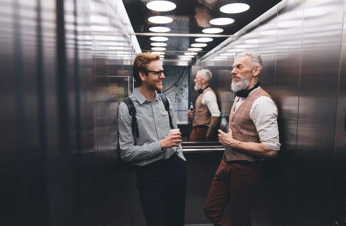 Two gentlemen chatting in the elevator.