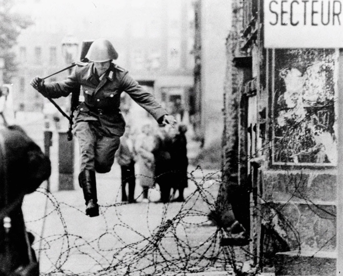Daring Escape: East German Soldier Defecting Over the Berlin Wall