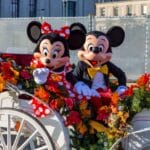 Mickey and Minnie Mouse in an open carriage.