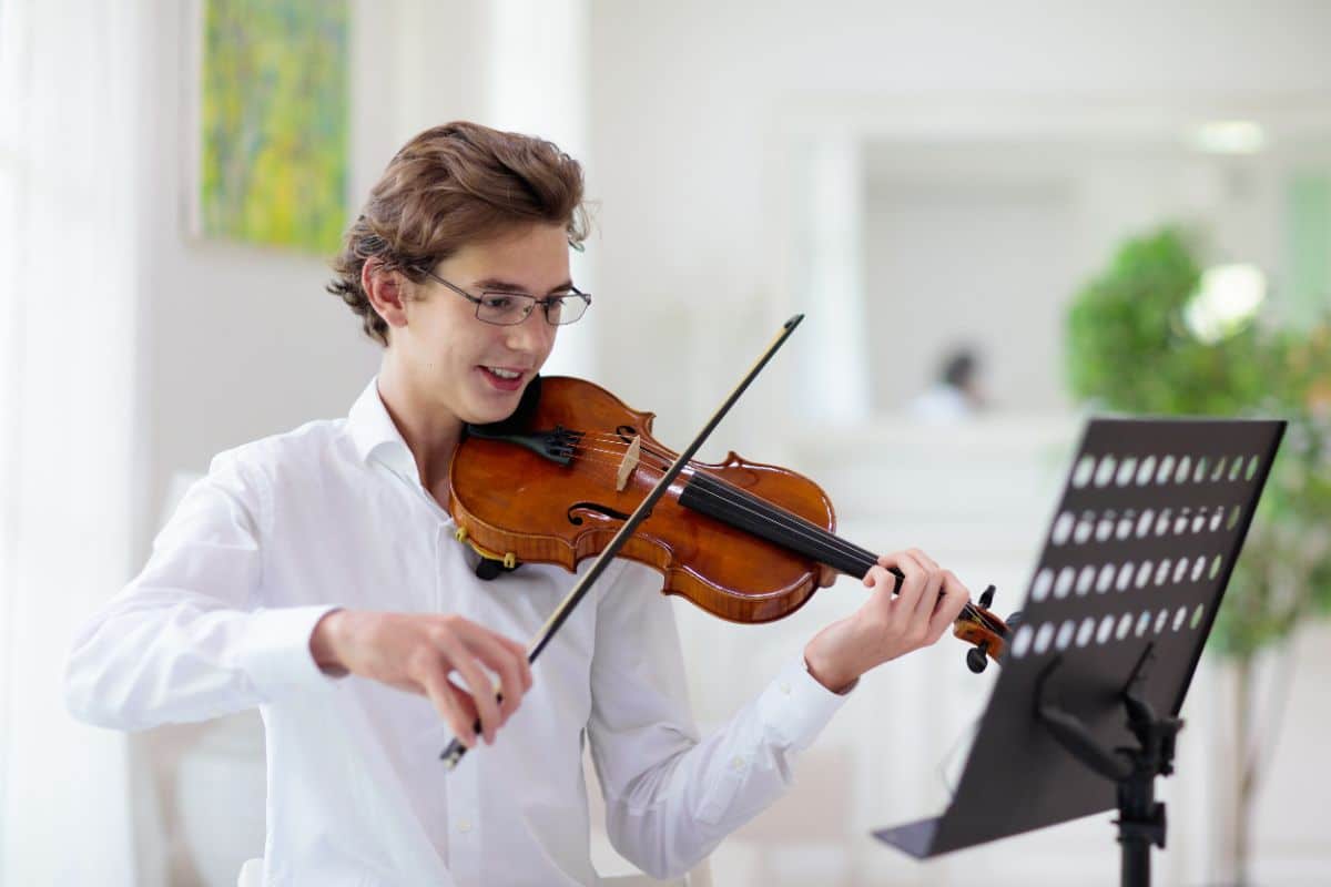A young man is playing the violin.