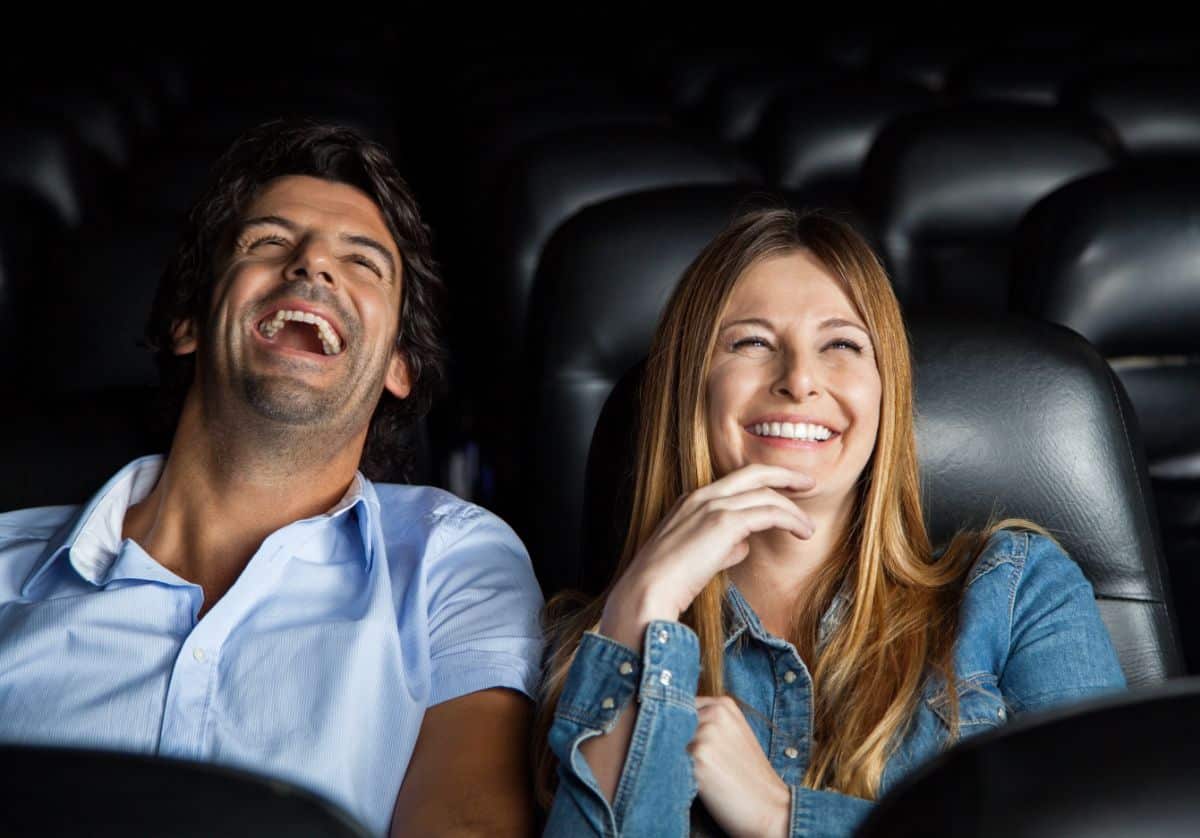 A happy couple in a cinema.