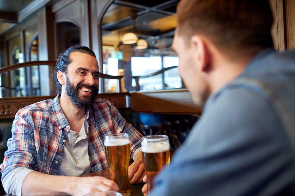 Two men talking in a bar.