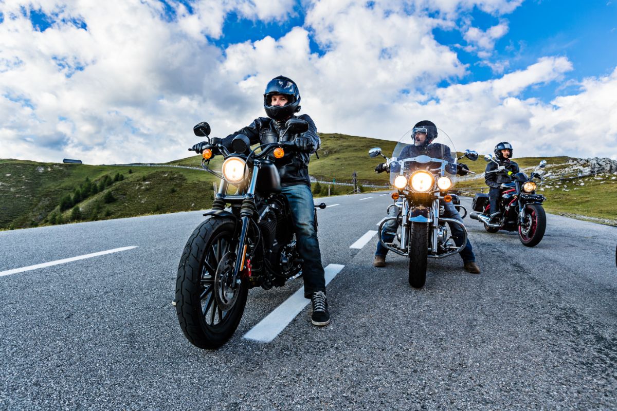 Three bikers on motorcycles on the road.