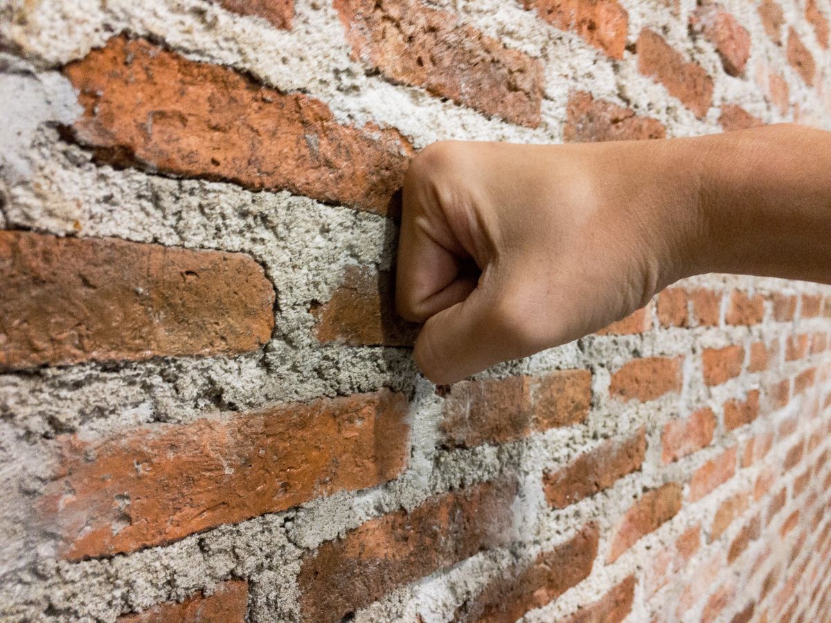 Punching a brick wall.