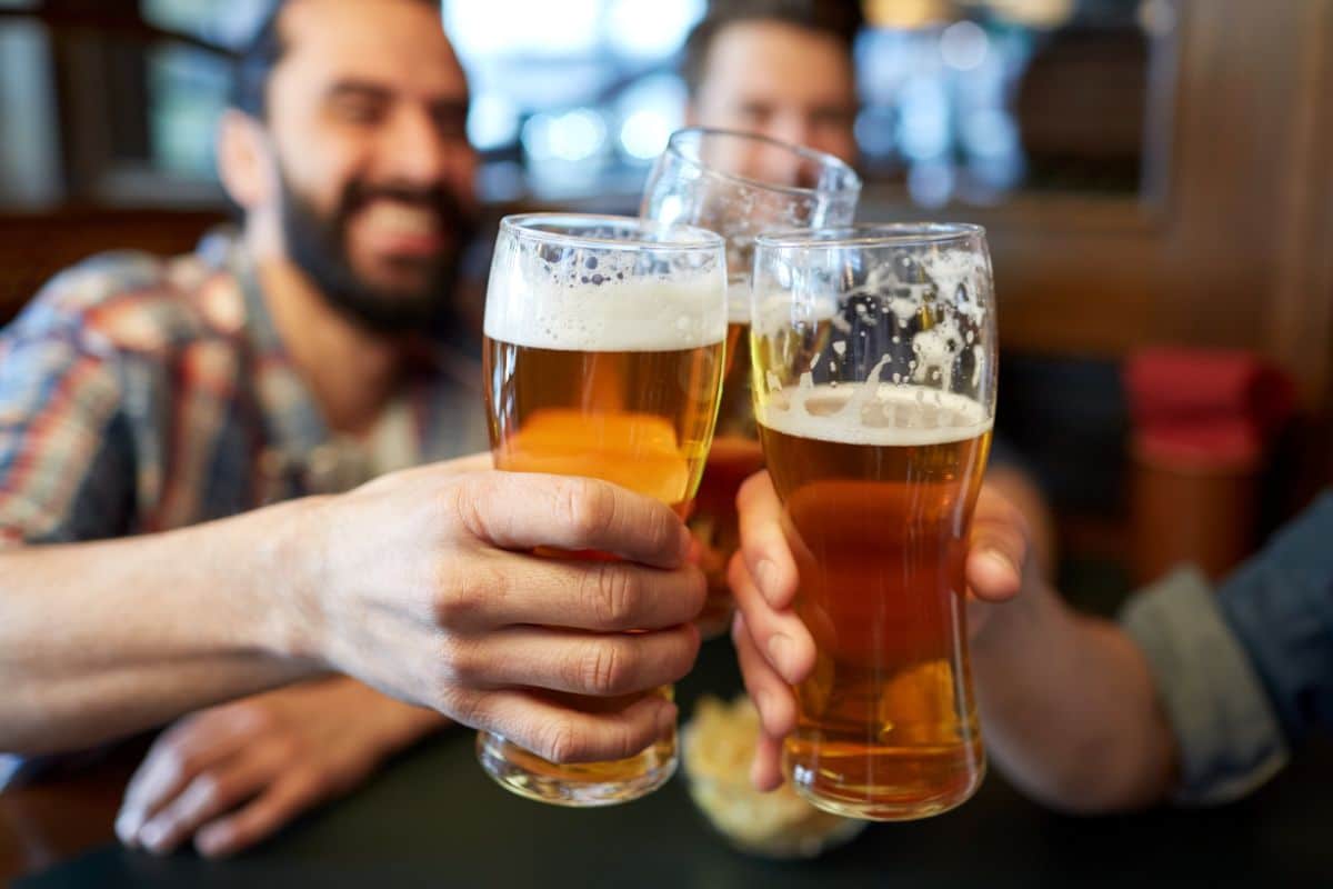 Three men toasting with beer.