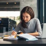 A young female college student studying in a library.